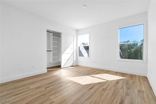 unfurnished bedroom featuring baseboards and wood finished floors