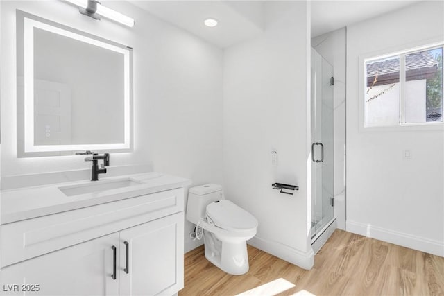 full bathroom featuring toilet, a shower stall, and wood finished floors