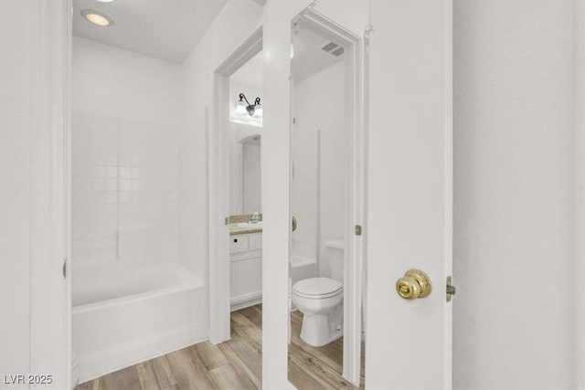 full bathroom featuring visible vents, vanity, toilet, and wood finished floors