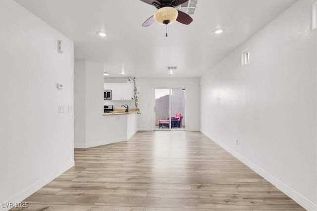 spare room with light wood-style floors, ceiling fan, baseboards, and recessed lighting