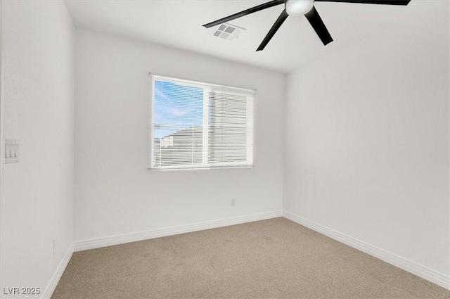 spare room with baseboards, carpet floors, visible vents, and a ceiling fan