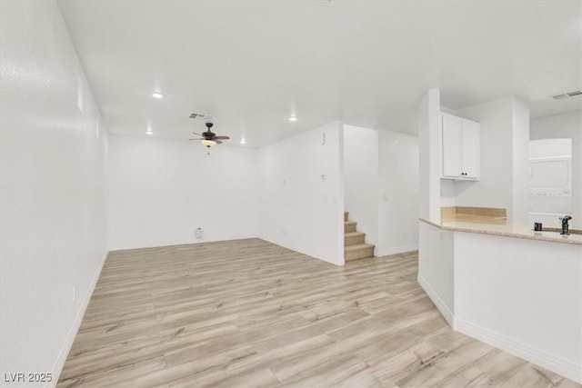 interior space featuring ceiling fan, light wood-style flooring, recessed lighting, visible vents, and stairway