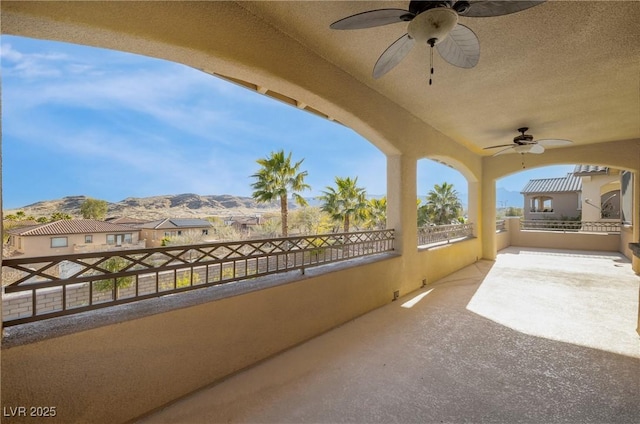 view of patio featuring a mountain view and a balcony