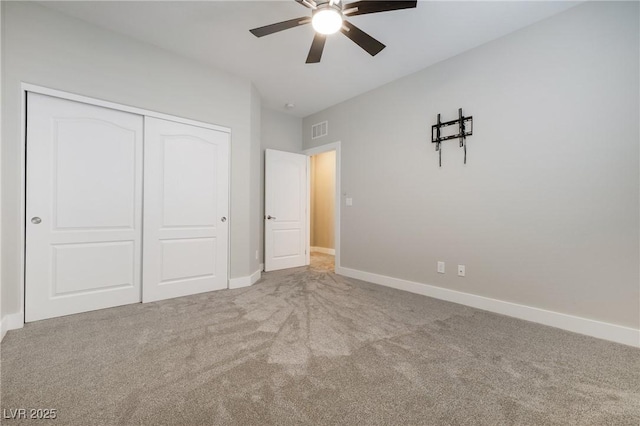 unfurnished bedroom with carpet floors, baseboards, and a closet