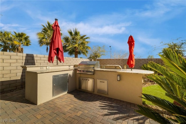 view of patio with fence and area for grilling