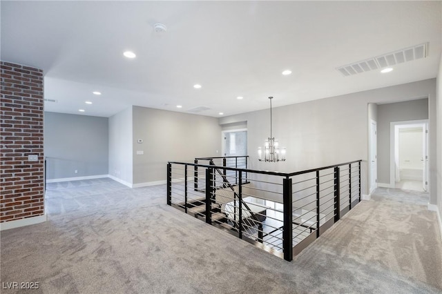 hall with recessed lighting, visible vents, carpet flooring, and an upstairs landing