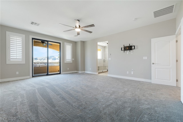 empty room featuring ceiling fan, visible vents, and carpet flooring