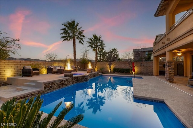 view of swimming pool featuring a fenced in pool, an outdoor fire pit, a patio area, and a fenced backyard