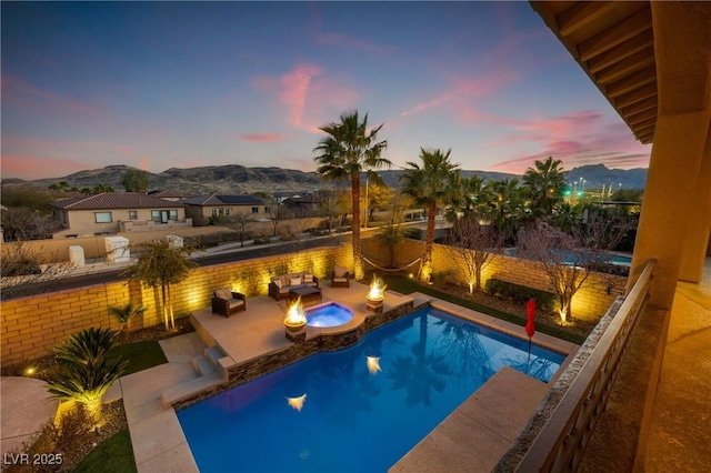 view of pool with an outdoor fire pit, a fenced in pool, a patio, a fenced backyard, and a mountain view