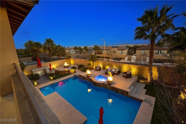 view of swimming pool featuring a fenced in pool, a patio, and a fire pit