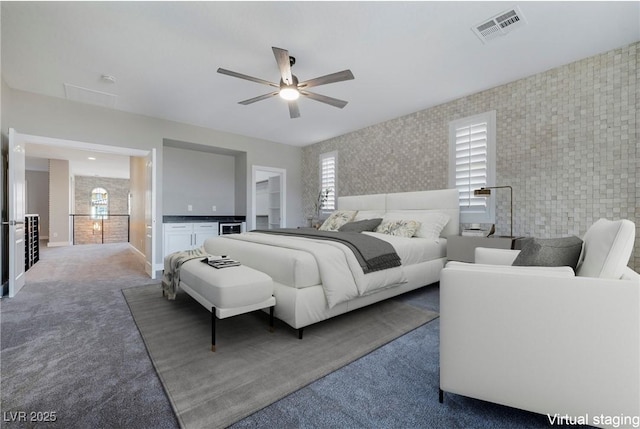 carpeted bedroom featuring a ceiling fan, visible vents, baseboards, and wallpapered walls