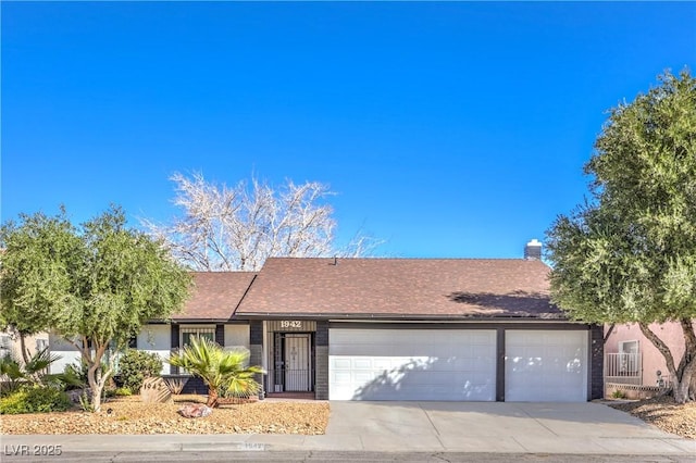 single story home featuring a garage, concrete driveway, and a chimney