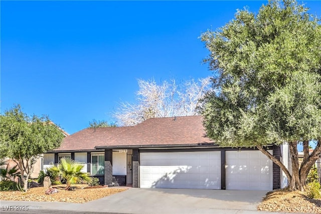 single story home featuring a garage, driveway, and roof with shingles