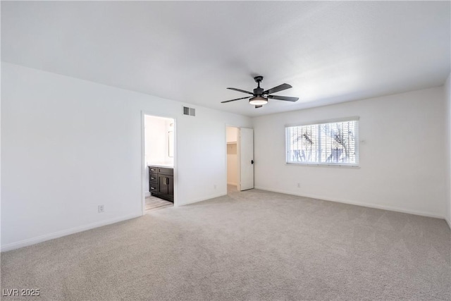 interior space featuring light carpet, baseboards, visible vents, and a ceiling fan