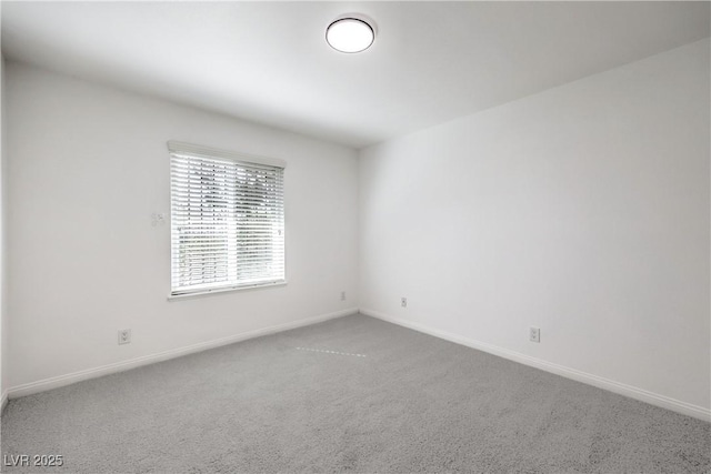 empty room with carpet and baseboards