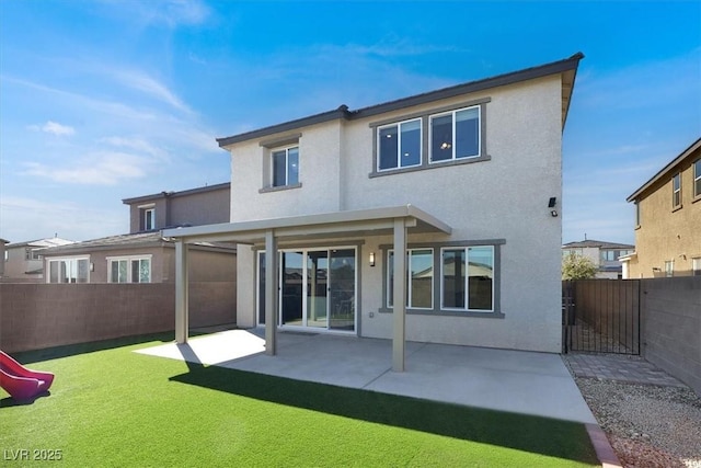 rear view of property with a patio area, a fenced backyard, and stucco siding