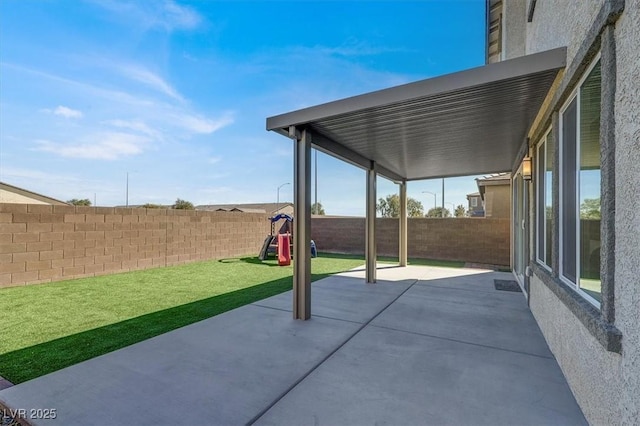 view of patio featuring a fenced backyard and a playground