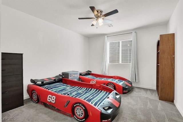 bedroom with baseboards, visible vents, a ceiling fan, and light colored carpet