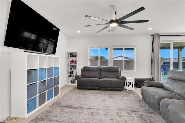 living area featuring a ceiling fan, recessed lighting, a healthy amount of sunlight, and visible vents