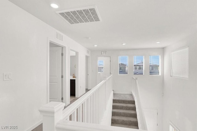 staircase with recessed lighting, visible vents, baseboards, and wood finished floors