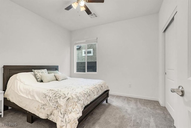 carpeted bedroom with baseboards, visible vents, and a ceiling fan