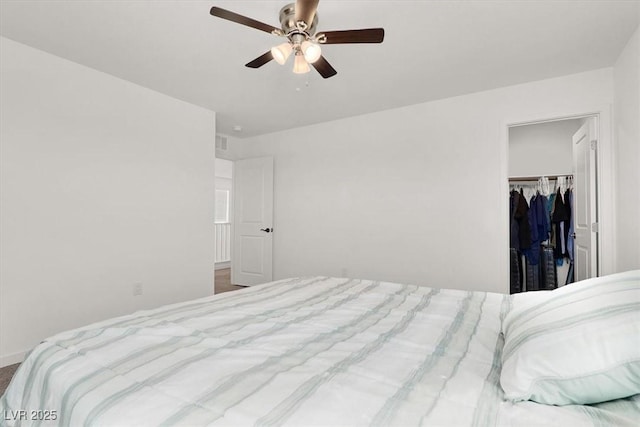 bedroom with a ceiling fan, a closet, visible vents, and a spacious closet