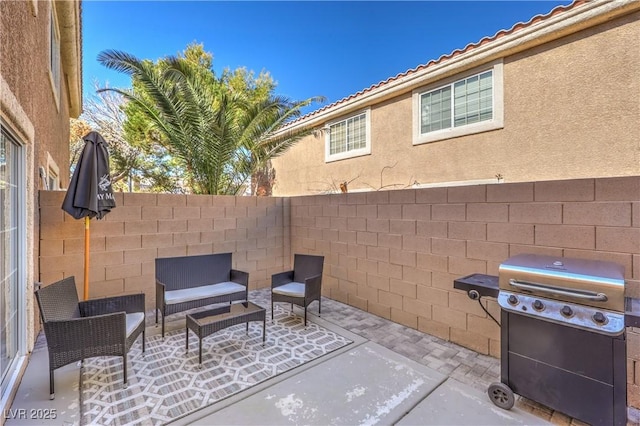 view of patio featuring fence, an outdoor living space, and area for grilling