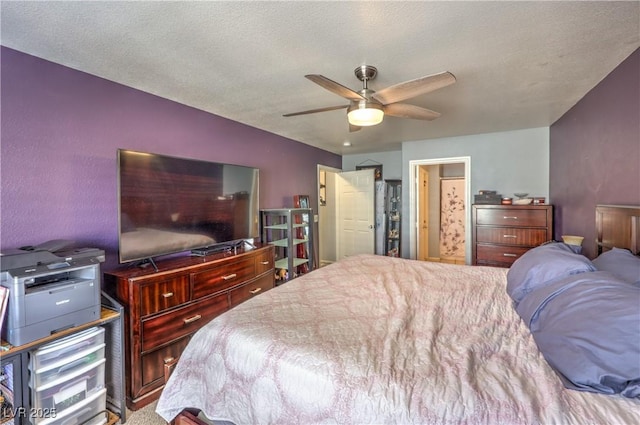 bedroom with a textured ceiling and a ceiling fan