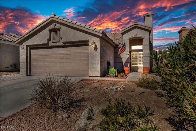 mediterranean / spanish-style home with an attached garage, driveway, a tile roof, and stucco siding