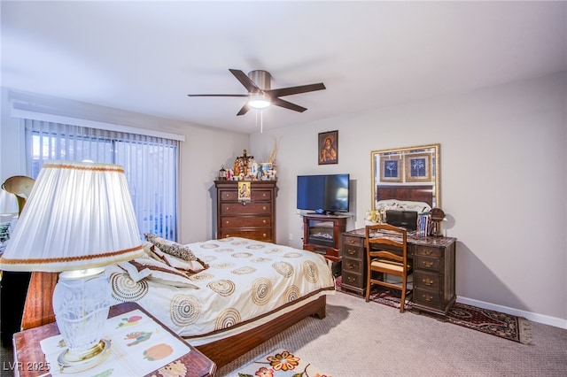 bedroom with ceiling fan, baseboards, and light colored carpet