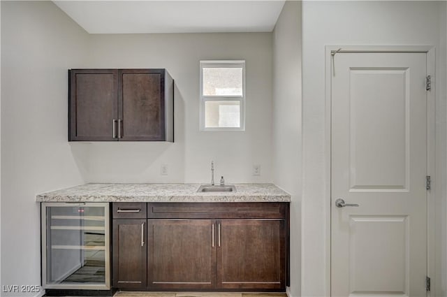 bar with wine cooler, bar, and a sink