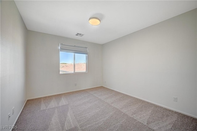 unfurnished room with visible vents, baseboards, and light colored carpet