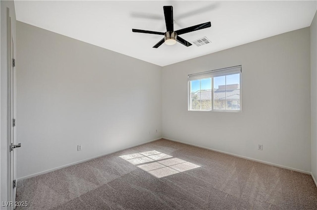 carpeted empty room with baseboards, visible vents, and ceiling fan