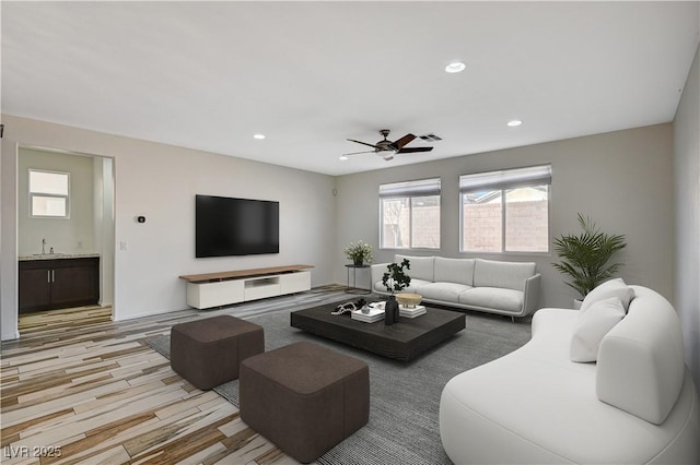 living area featuring recessed lighting, visible vents, light wood finished floors, and ceiling fan