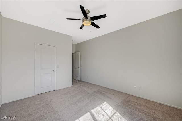 unfurnished bedroom featuring a ceiling fan, baseboards, and light carpet