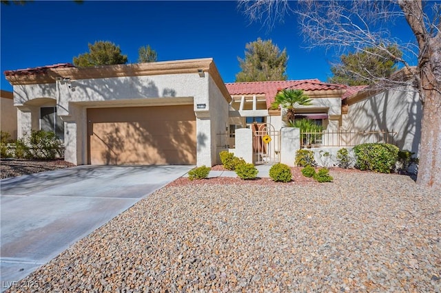 view of front of house featuring a garage, a tile roof, driveway, a gate, and stucco siding