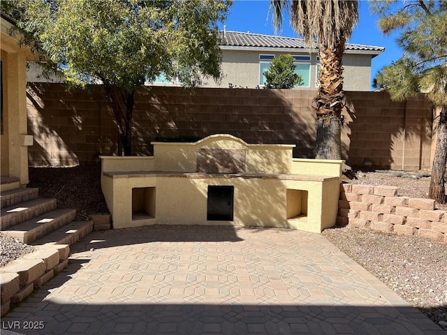 view of patio featuring fence