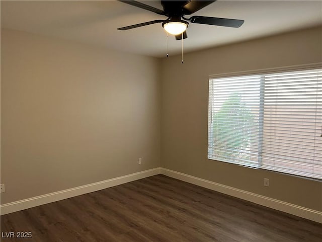 empty room with dark wood-style floors, baseboards, and a ceiling fan