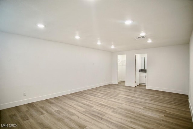 unfurnished room with baseboards, recessed lighting, visible vents, and light wood-style floors