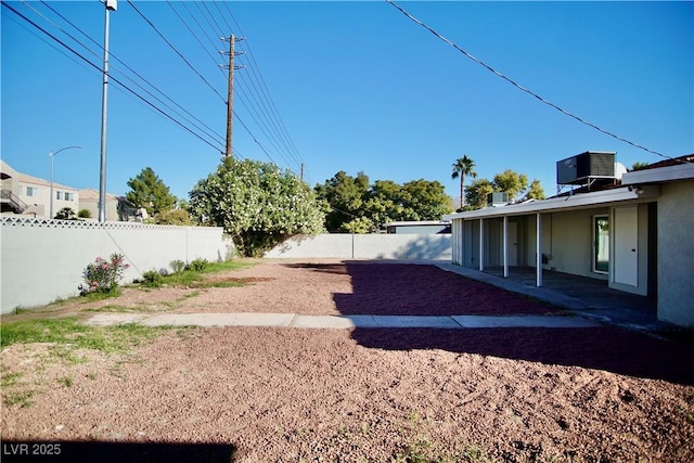 view of yard with a fenced backyard and cooling unit