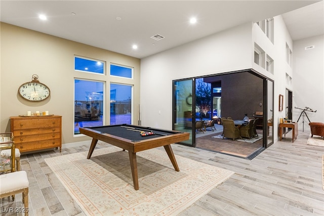 playroom with a high ceiling, visible vents, light wood finished floors, and recessed lighting