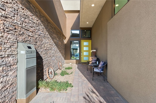 doorway to property featuring stucco siding