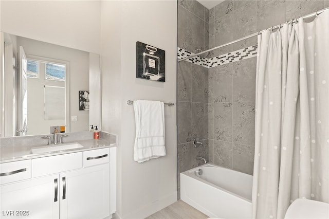 bathroom featuring shower / bath combination with curtain, vanity, and baseboards