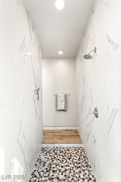 bathroom with recessed lighting and tiled shower