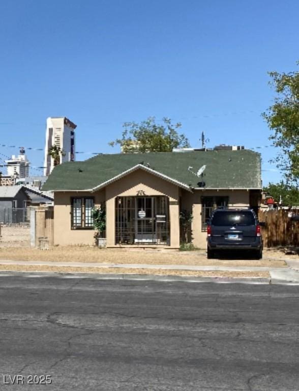 view of front of property with fence and stucco siding