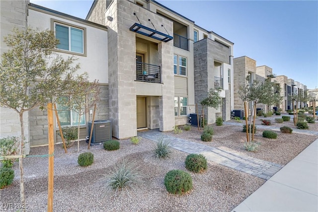 view of building exterior featuring a residential view and cooling unit