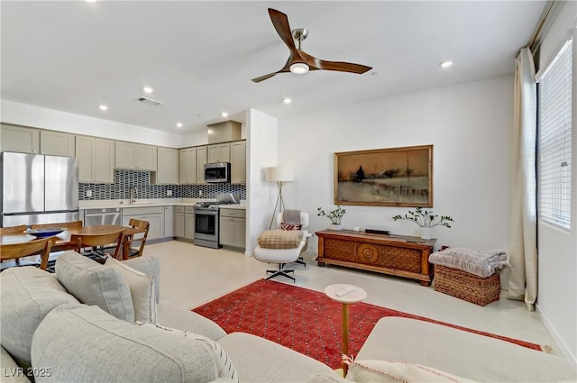 living room featuring visible vents, a ceiling fan, and recessed lighting