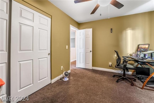 office featuring dark colored carpet, ceiling fan, and baseboards