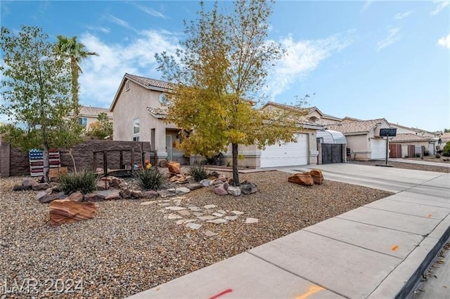 view of front of property with a garage, concrete driveway, a tile roof, and stucco siding