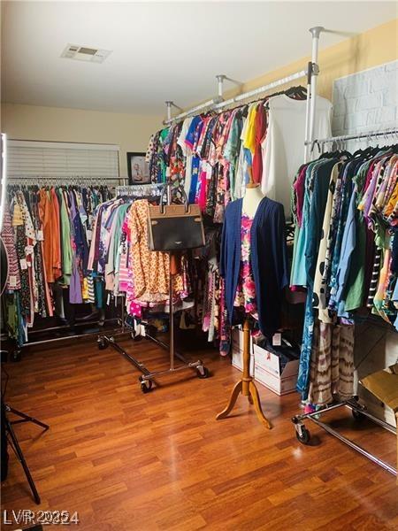 spacious closet featuring visible vents and wood finished floors